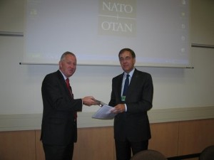 Ambassador Maurits Jochems (r), deputy assistant secretary general for operations, NATO Headquarters (HQ), receives a certificate of appreciation from Rear Adm. Willem Voogt, RNLN (Ret.), chapter president, for speaking at the October meeting.